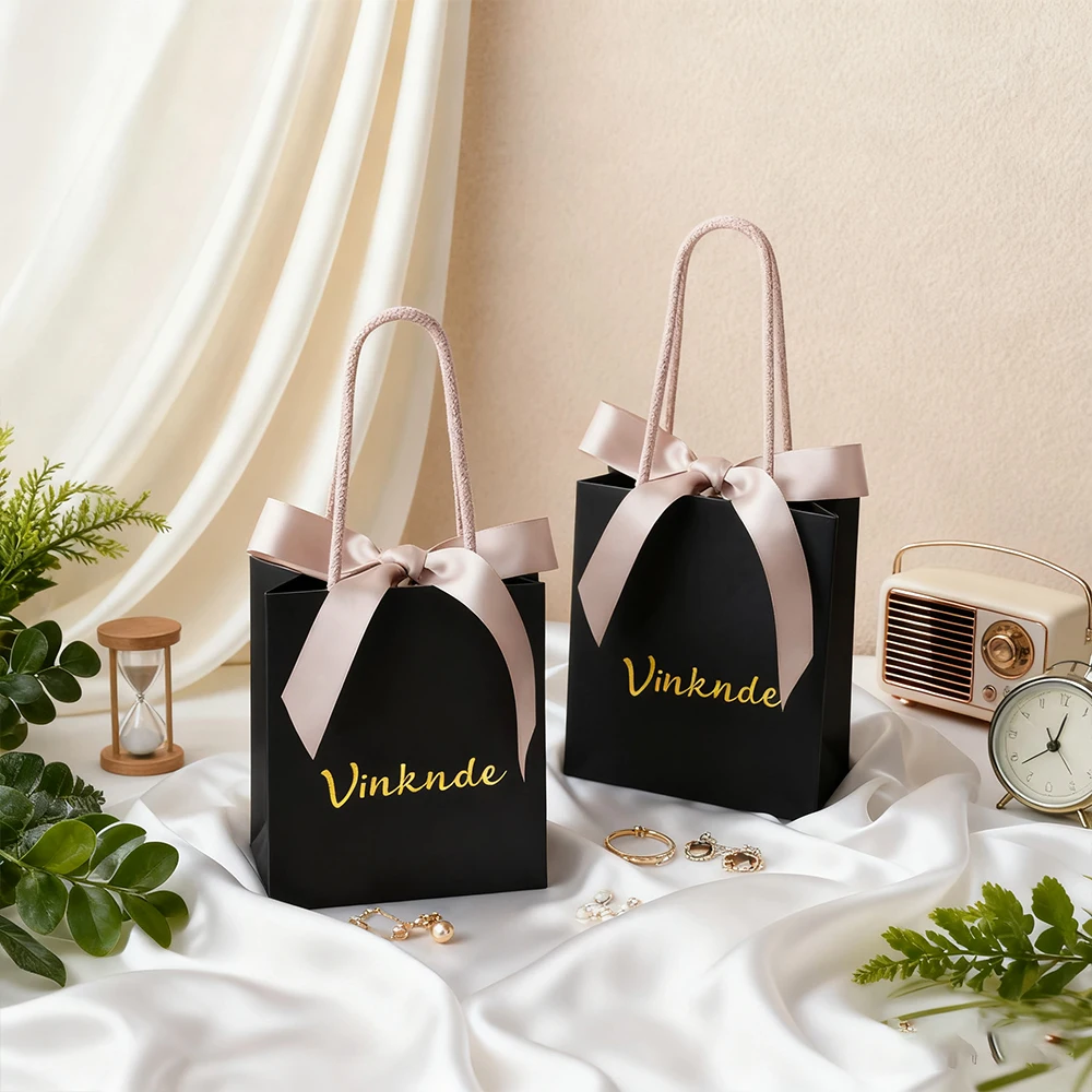 

Оптовая продажа, необычная черная бумажная сумка-тоут, бумага для покупок, индивидуальная сумка из крафт-бумаги с ручкой из ленты, сумка для одежды, ювелирных изделий