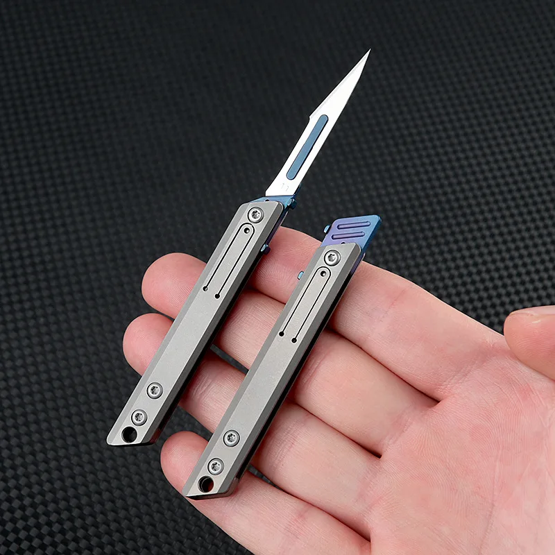 ใหม่ Mini Titanium Alloy มีดพับกลางแจ้ง Camping แบบพกพา EDC มีดมาพร้อมกับใบมีดฟรี 10 ชิ้น