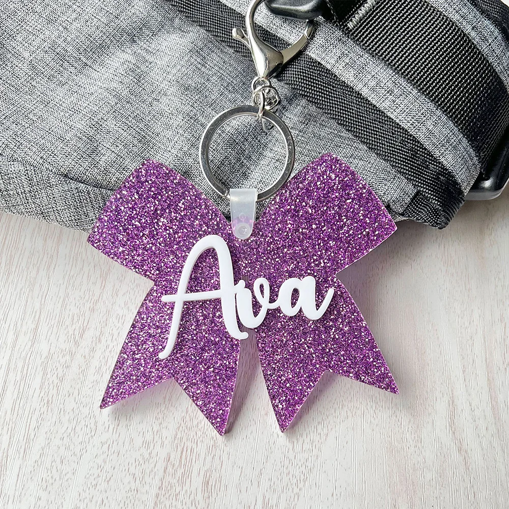Custom acrylic winter and autumn keys, cheerleading bow packaging cards, cheerleading bow with names, custom acrylic keychains,
