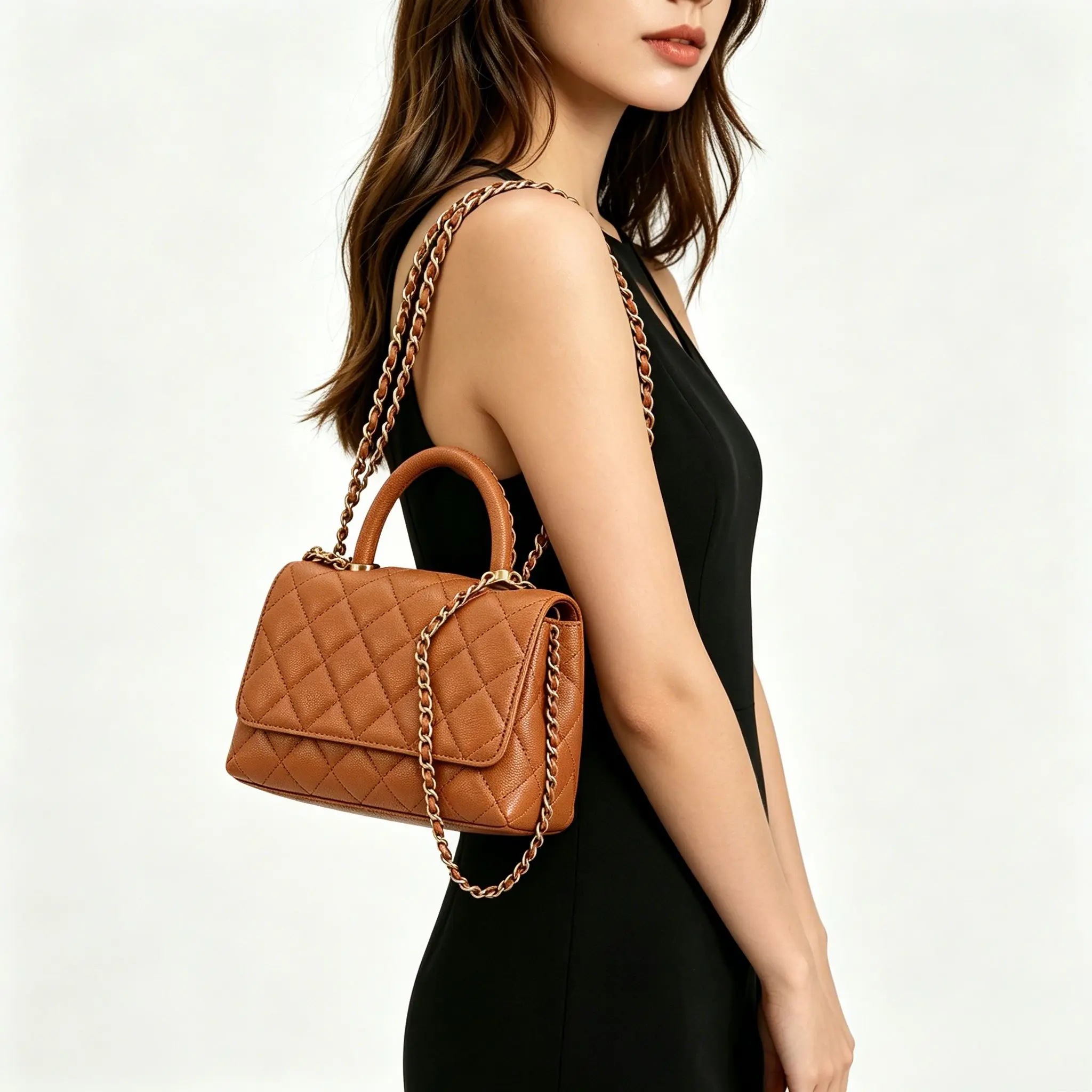 

Classic mini flap bag crafted from cognac quilted leather, featuring a top handle and a detachable leather-woven gold chain strap.
