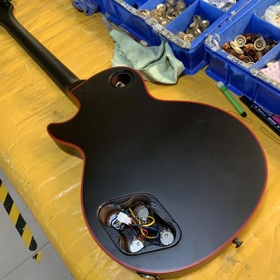 Customized black matte electric guitar, rosewood fingerboard, black hardware, red binding