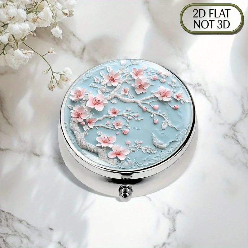 Single-piece flat portable round metal pill box, adorned with exquisite peach blossom and plum blossom patterns, designed with a light blue background, suitable for storing essential medicines, ideal for organizing vitamins, storing small accessories or coins, especially convenient for travel use, flat design
