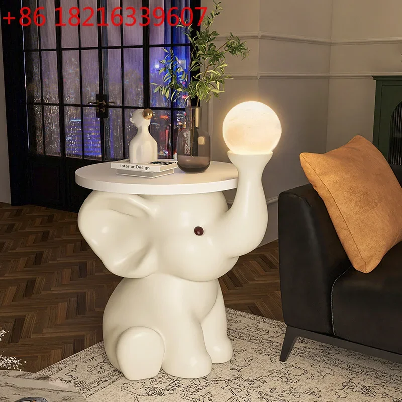 Elephant floor ornament, living room, large TV cabinet, sofa next to a few cream wind decorations