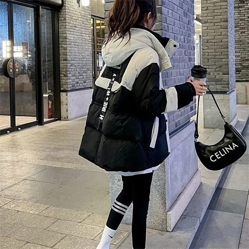 Chaqueta de algodón Parker negra de longitud media para mujer, nueva versión coreana 2026, abrigo con capucha de algodón suelto y empalmado, cálido para invierno.