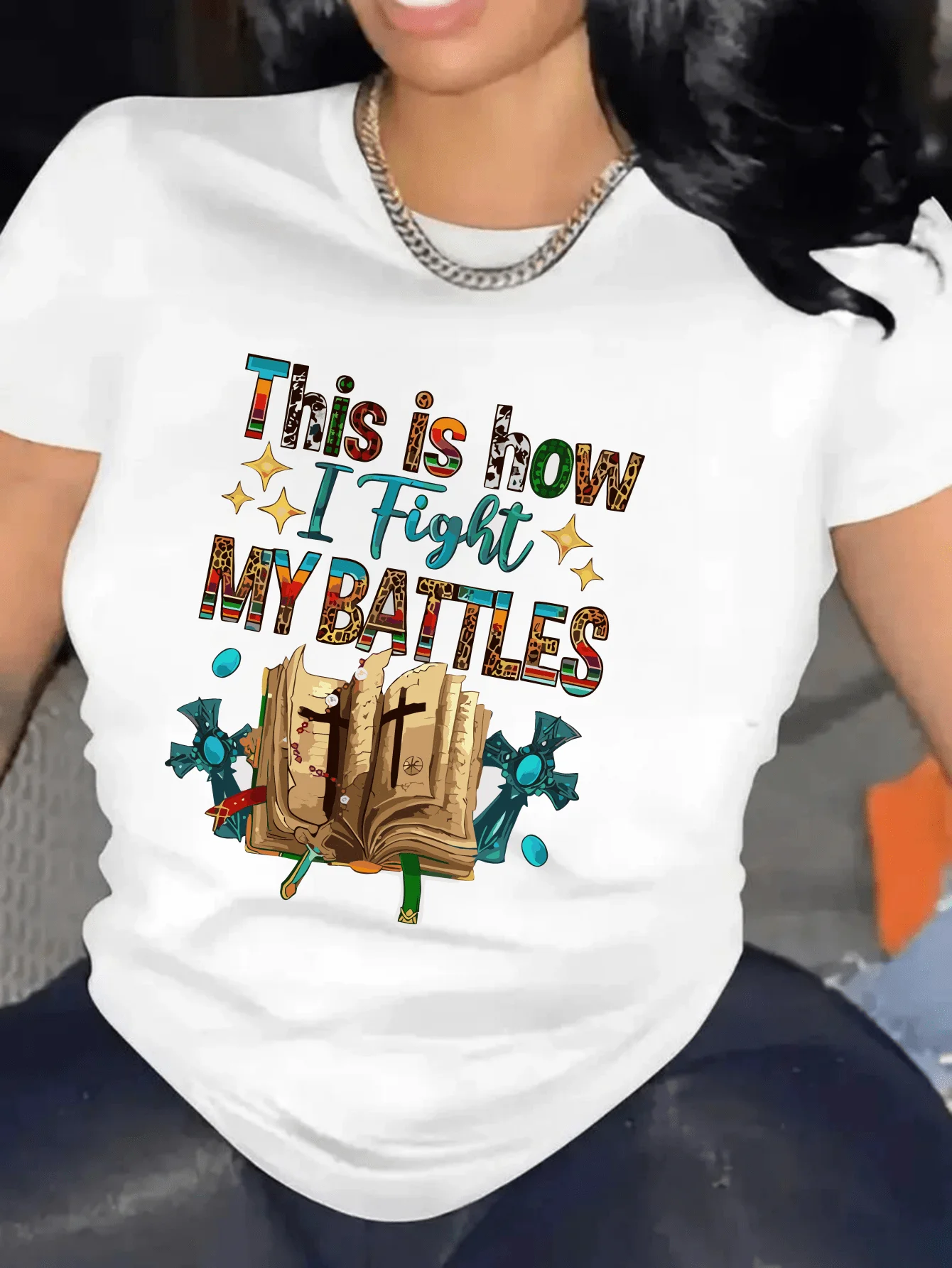 Battles stylish women's crew-neck T-shirt featuring colorful lettering and book graphics; suitable for spring and summer wear.
