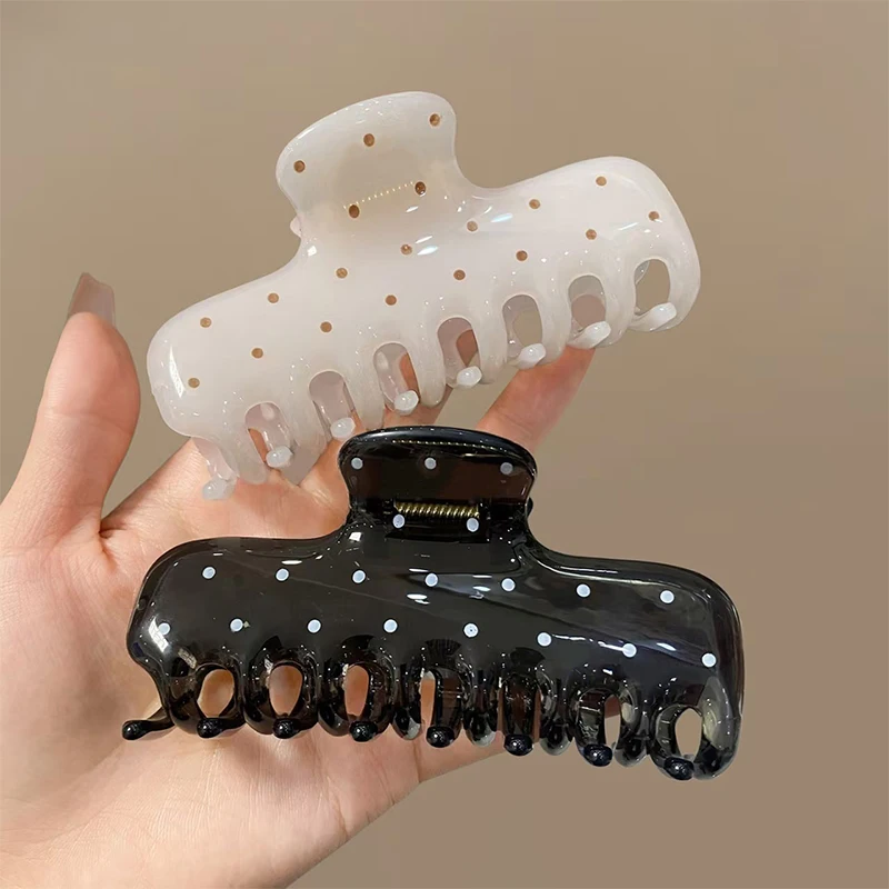 Korean-style large oval cutout claw clip with polka-dot pattern; a minimalist, elegant 