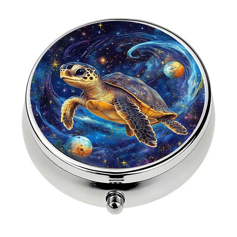 A small pill box with a cosmic turtle design, featuring three compartments, is perfect for carrying in a handbag. This metal mini storage box is a unique travel gift.