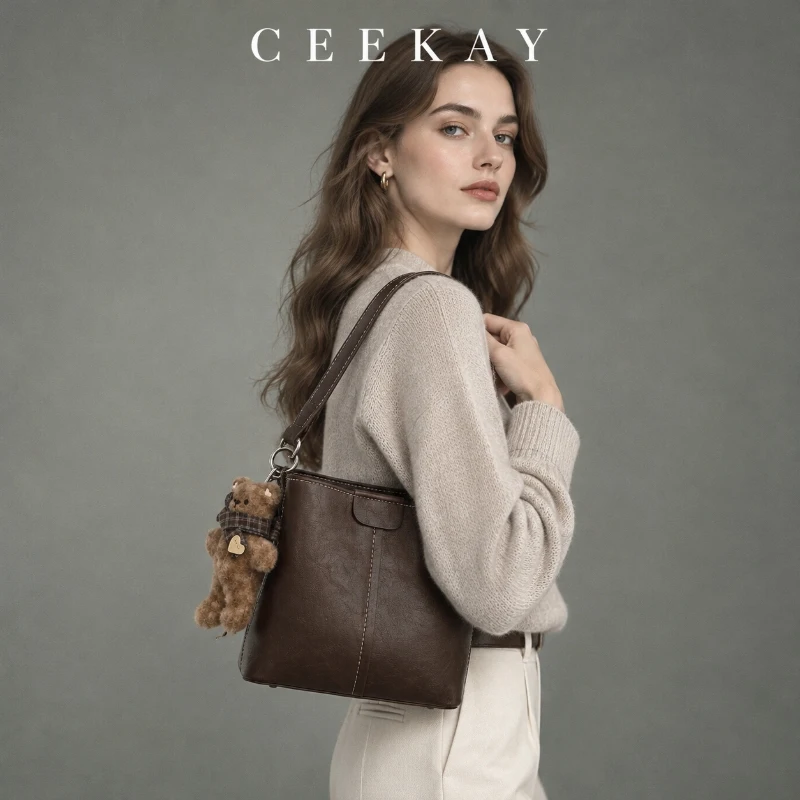 CEEKAY Brown Textured Leather Bucket Bag Woven Handle Bear Charm Adjustable Strap Daily Utility Roomy Elegant Purse Women