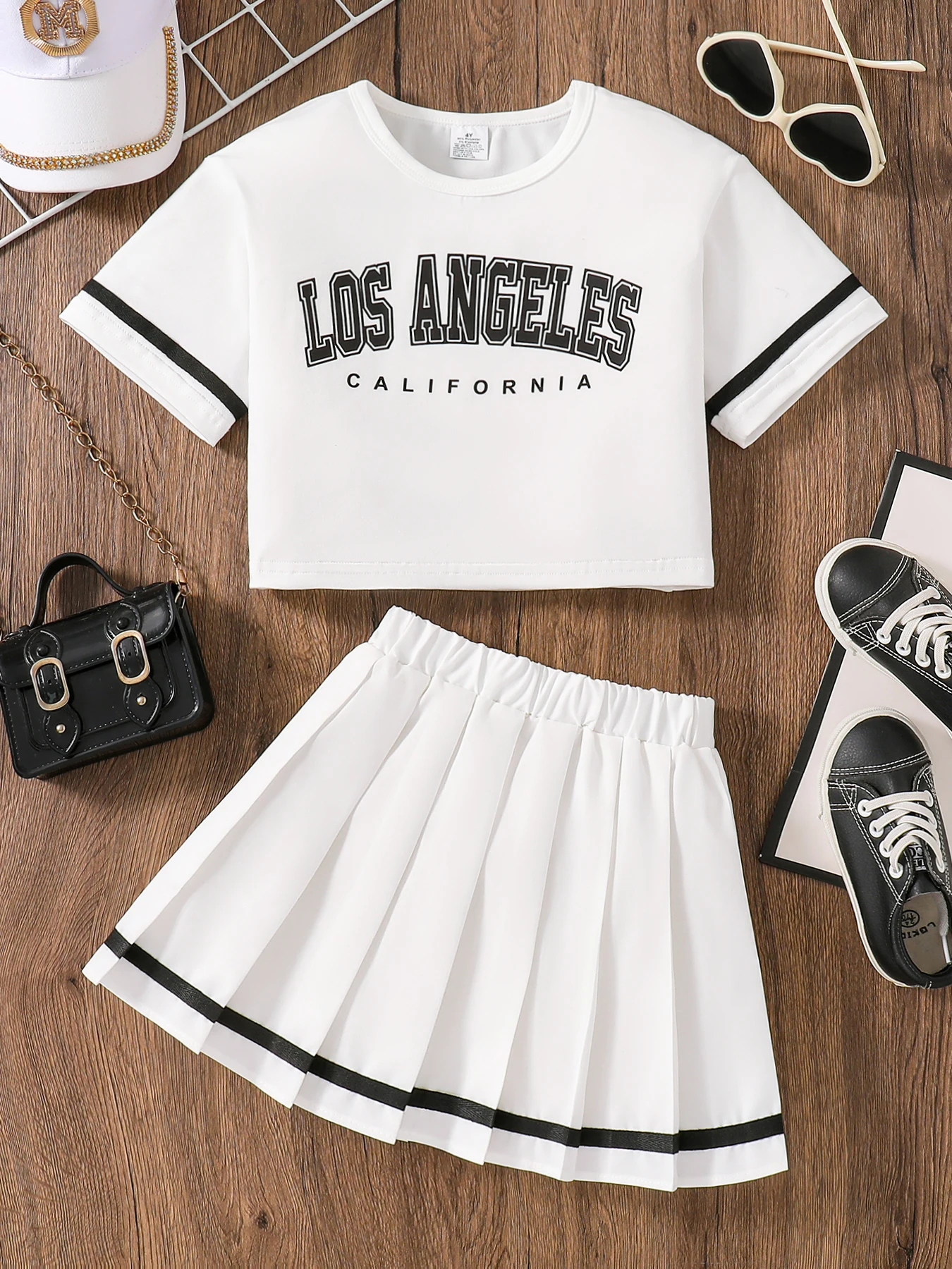 Conjunto de 2 piezas para niñas, traje de verano moderno y sencillo, top de manga corta con cuello redondo y estampado de letras en inglés para niñas pequeñas + falda plisada a rayas de color sólido con cintura elástica, ropa para niños jóvenes y cómodos todos los días, traje femenino y elegante para edades 4-5-6-7-8