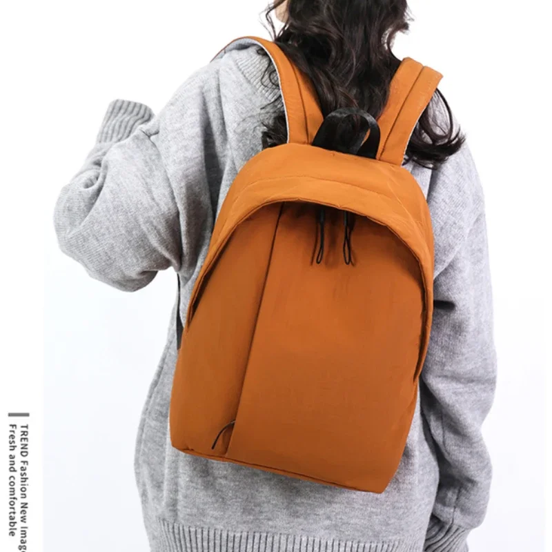 

2025 New Nylon Solid Color Outer Frame Backpack Air Cushion Strap Soft Handle Casual Backpack Soft Simple Designer Handbag