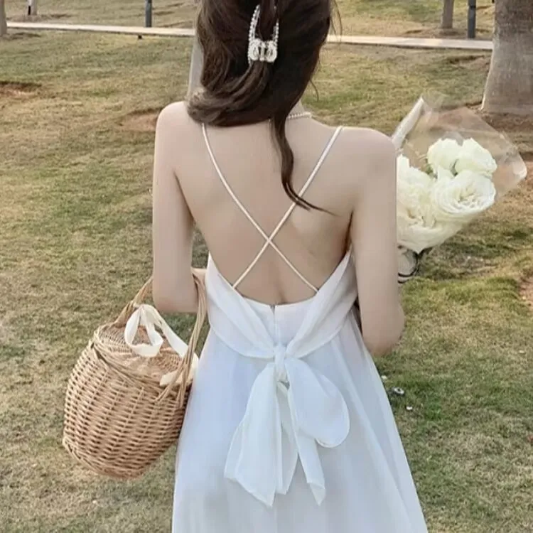 Beach vacation backless suspender dress for women's summer new white bow temperament medium length dress