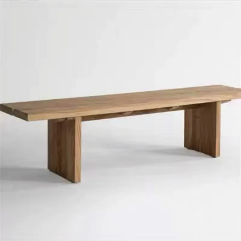 

The back of the wabi-sandy carbonized sofa leans against the back of a few ash wood black simple benches