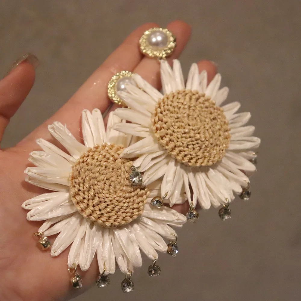 Raffia straw exaggerated earrings, Bohemian style, sunflower motif, beach vacation vibe, simple yet sophisticated look.