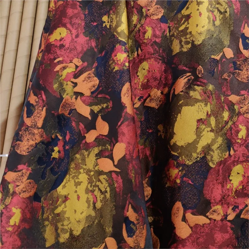 The fabric of oil-painted style clothing is a blurry and abstract orange-toned contrasting jacquard trench coat dress