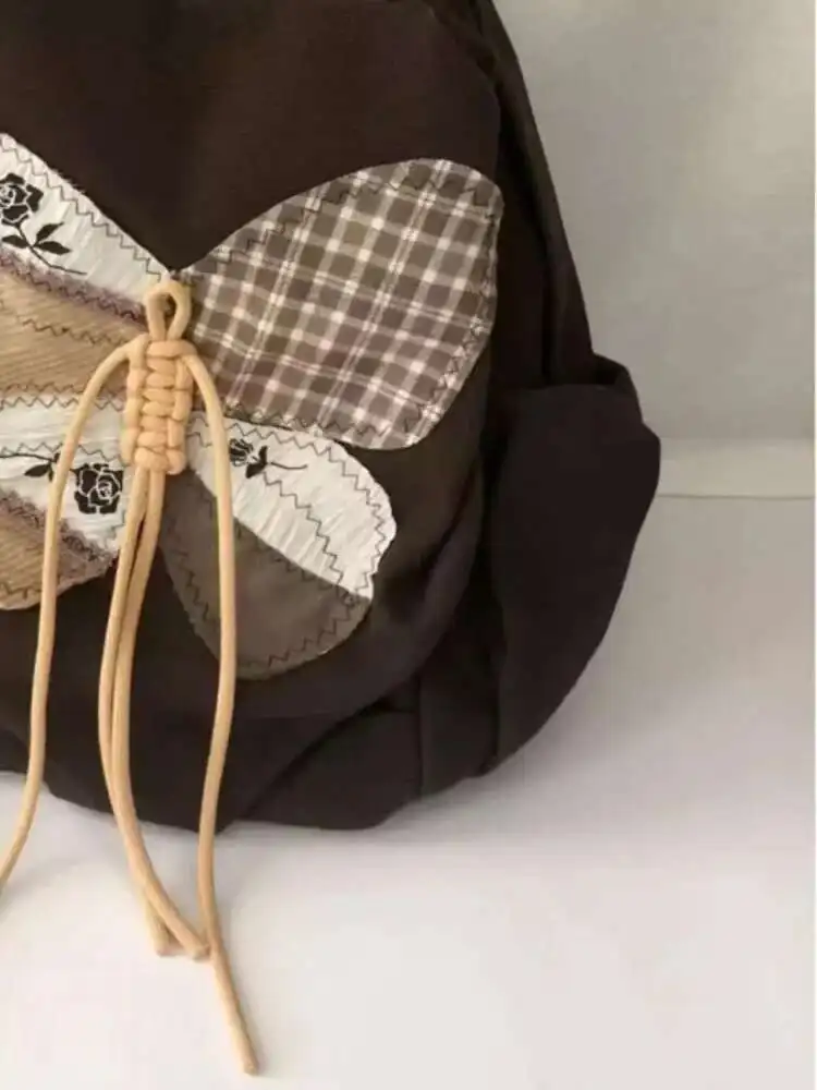 2025 ใหม่ Patchwork ผีเสื้อกระเป๋านักเรียนกระเป๋าเป้สะพายหลังไหล่กระเป๋านักเรียนวัยรุ่นของขวัญ B1979 hit