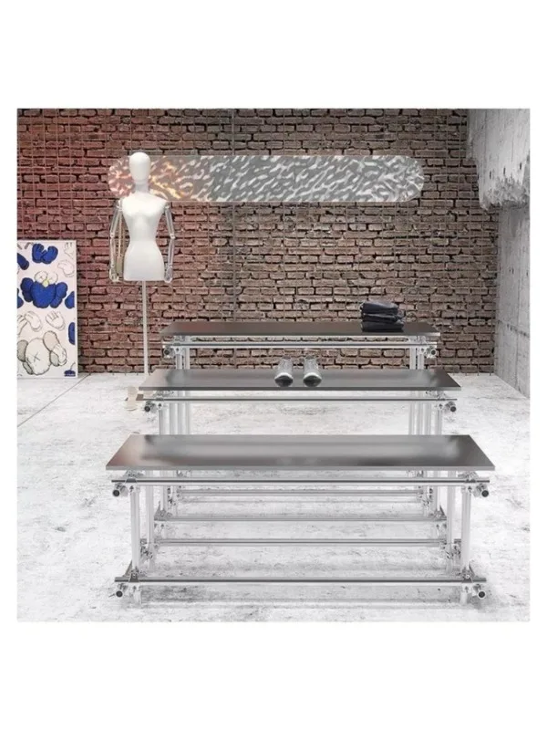 #In the middle of the island table in the clothing store, stainless steel men's clothing store shoes and bags are placed