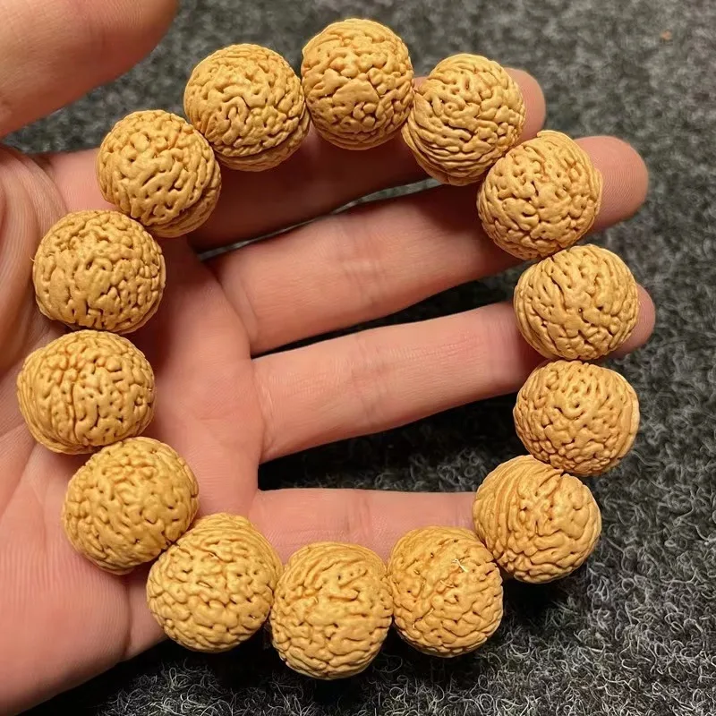 

bracelet, natural wild short-stemmed walnut with patina, small peach kernel beads for cultural appreciation a