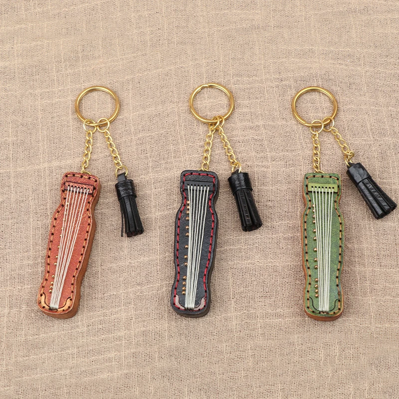 

Genuine leather mini guqin keychain handmade bag pendant traditional musical instrument vintage cowhide folk music ornament gift