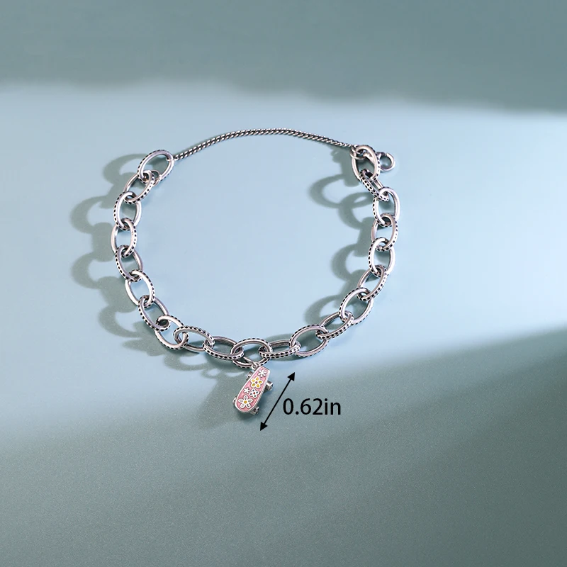 

Genuine 925 sterling silver James Avery Textured Oval Charm Bracelet paired with an enamel flower skateboard pendant