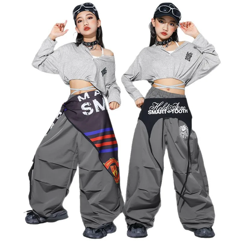 

Комплект для девочек: укороченный топ с K-pop надписями и брюки карго. Детская уличная одежда в стиле K-pop групп, для хип-хопа, уличных танцев, джаза. Подростковые комплекты.