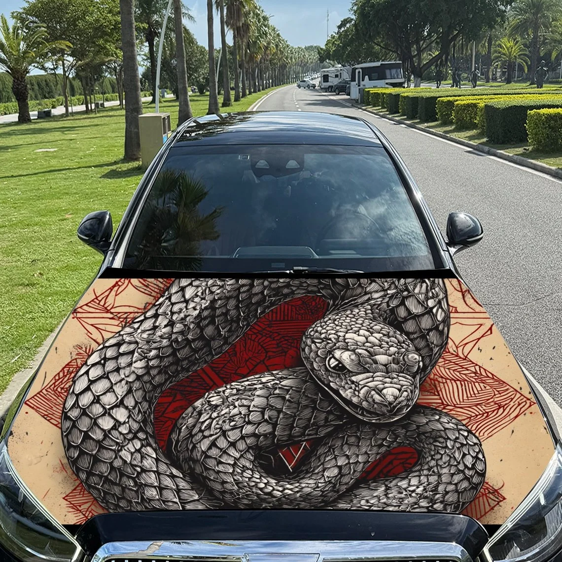 A striking car hood wrap featuring a detailed black and white snake design with red accents, perfect for bold vehicle customizat