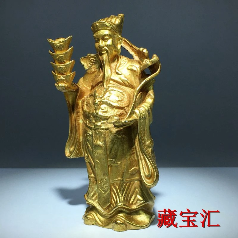 gold-plated brass God Wealth makes a fortune financial resources are rolling standing like a bronze statue  of Wealth to worship