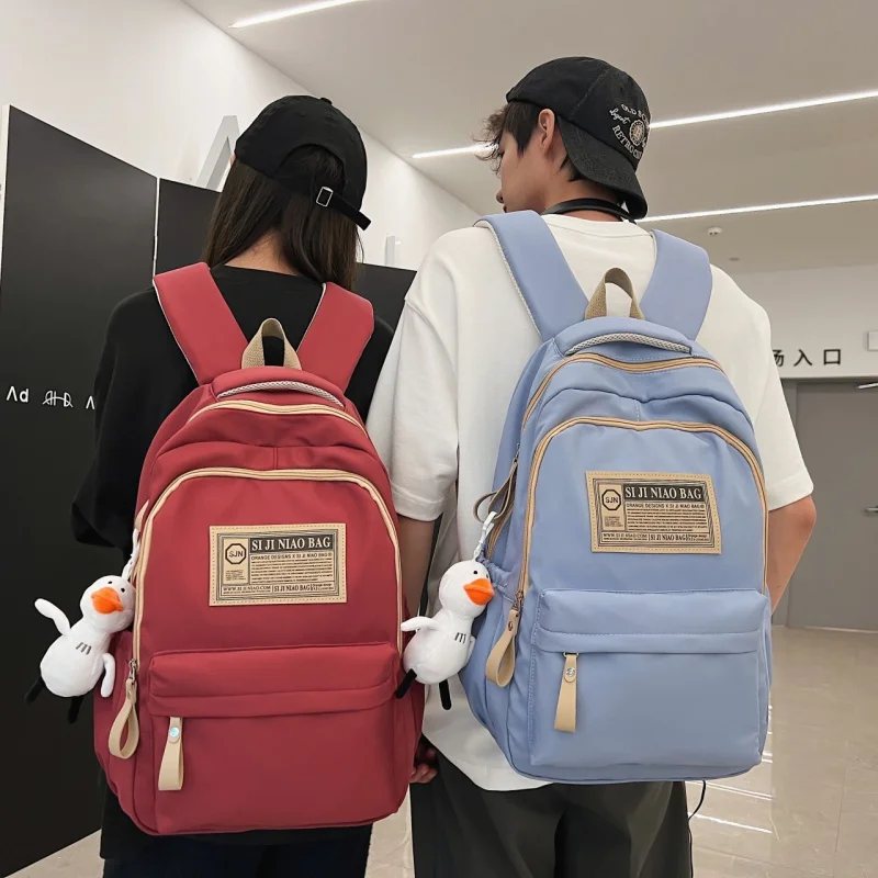 Tas ransel gaya Korea pria dan wanita, tas ransel kasual sekolah SMA warna polos kapasitas besar, serbaguna mode