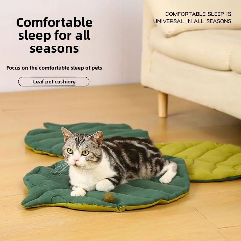 A cat sleeping on a Leaf Pattern Cat Sleeping Mat shaped like a leaf.