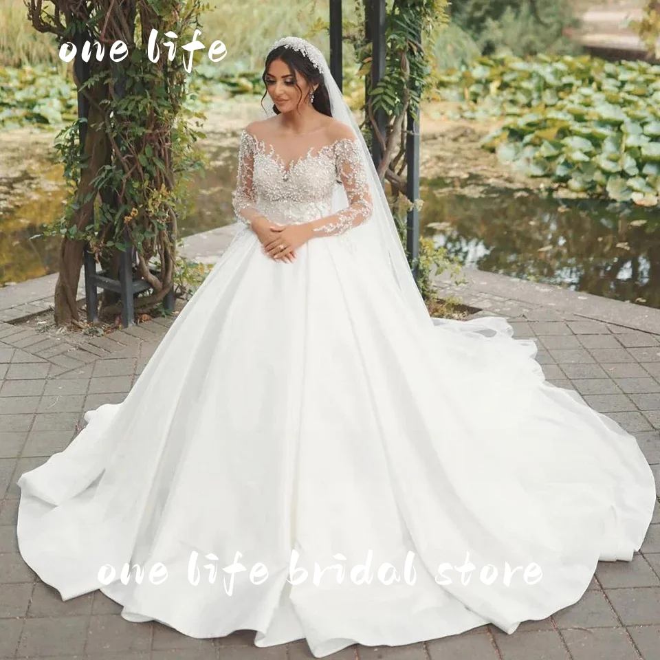 ชุดแต่งงานแบบบอลกาวน์ประดับลูกปัดหรูหราสไตล์ดูไบจาก Onelife รุ่นปรับแต่งได้ ปี 2025 คอซีทรูแบบเจ้าหญิง สำหรับเจ้าสาว ชุดเจ้าสาว Vestido De Novia