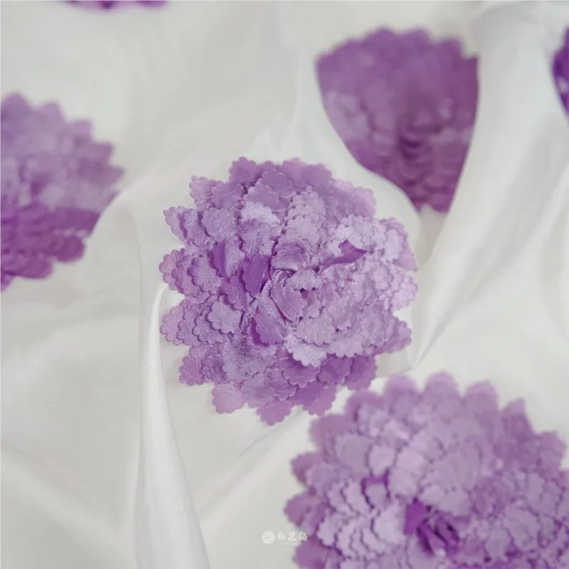A dress made of purple three-dimensional floral cut fabric with slightly lustrous white base designed by designer