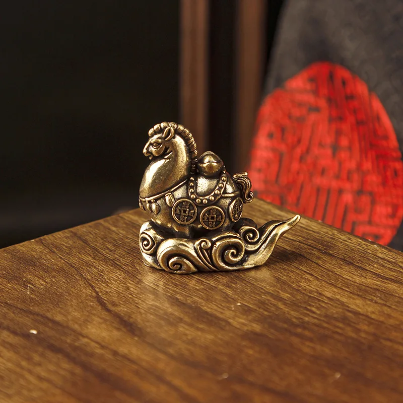 Antique brass figurine with abstract auspicious cloud design, symbolizing wealth and prosperity, zodiac horse desktop deco
