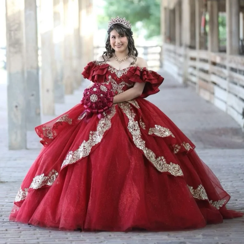

Блестящее красное платье с открытыми плечами, кристаллами, золотистым блеском, кружевными вставками, длинным шлейфом и бантом. Платье для 15-летия (Quinceañera). Возможно изготовление на заказ.