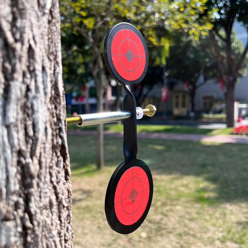 Double-headed Spinner Plinking Steel Targets with Orange Stickers Screwed and Attached to a Tree with Spare Parts Needed