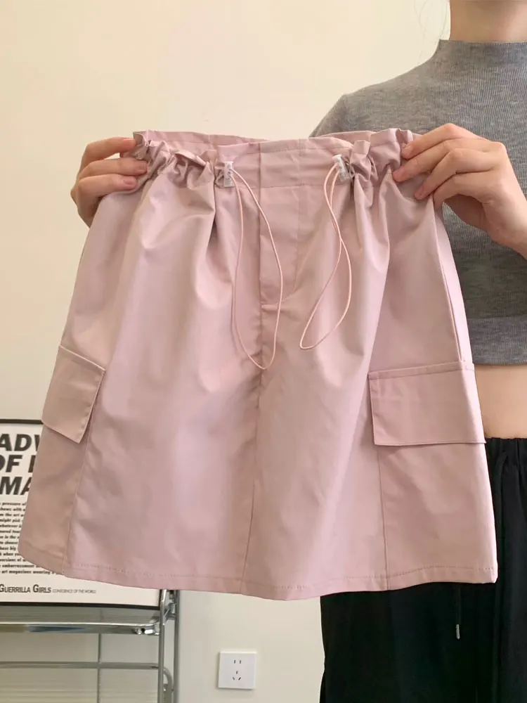 

Розовая милая офисная юбка для женщин, лето 2026, новая модель, с завышенной талией, стройнящая, в американском стиле, А-силуэт, с запахом, средней длины