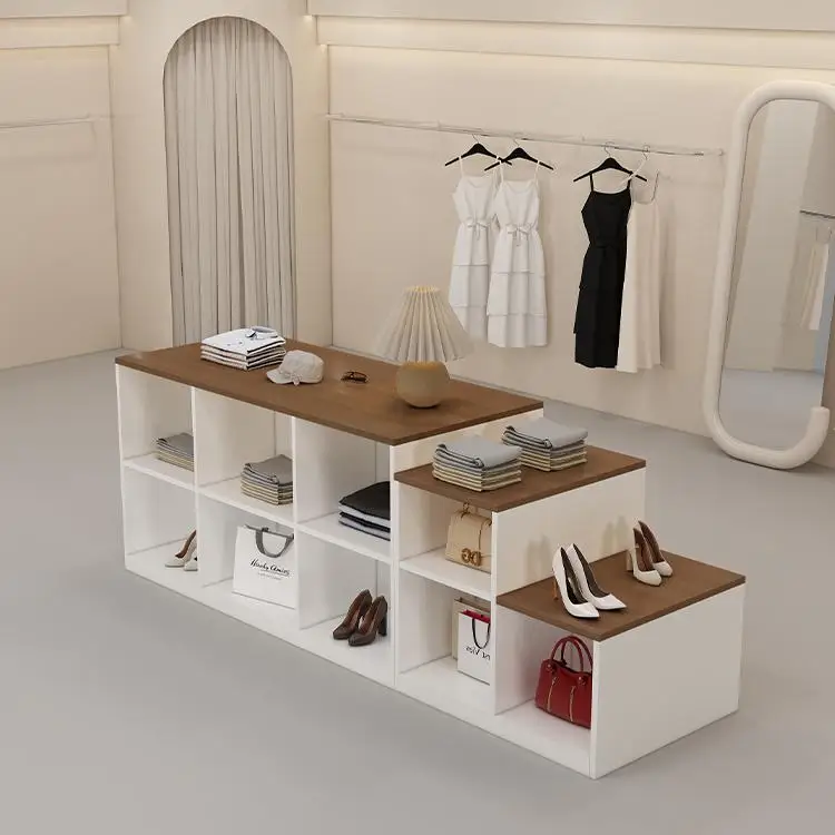 In the clothing store, the island table is placed in the middle of