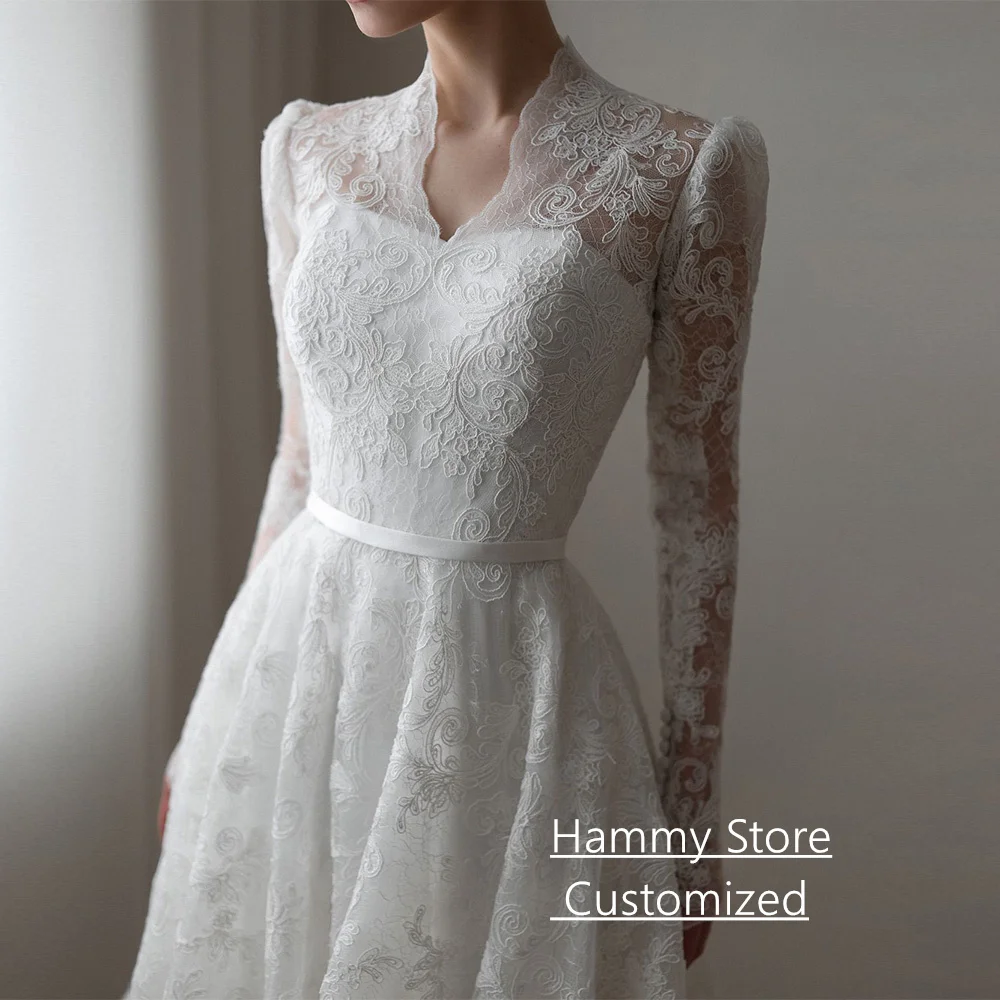 فستان زفاف دانتيل رائع فستان زفاف عربي مخصص بأكمام طويلة ورقبة على شكل V وأزرار وسحاب ذيل محكمة فساتين العروس السعودية