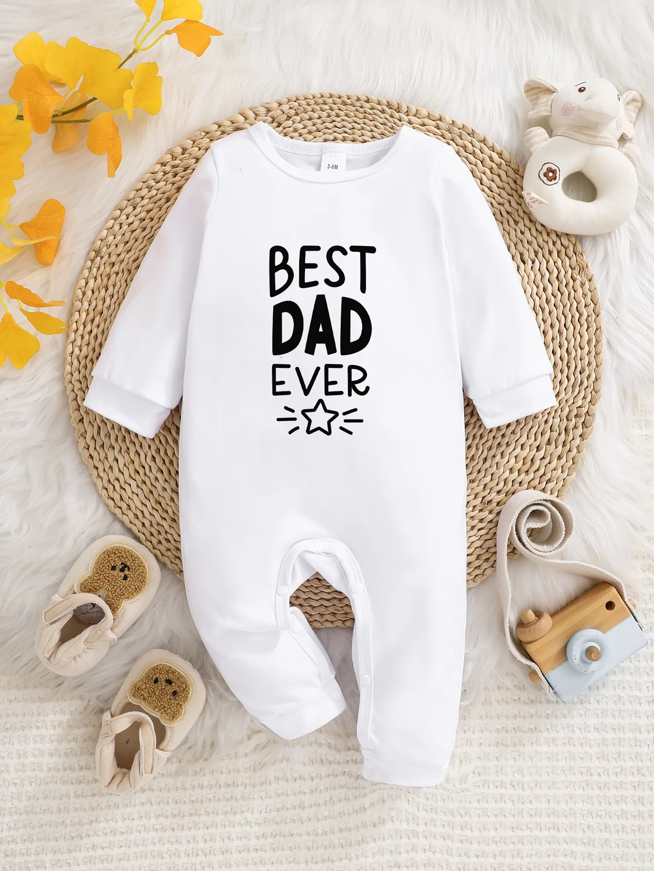 A baby long-sleeved onesie with interesting letter prints. It features a buttoned design for easy putting on and taking off, and