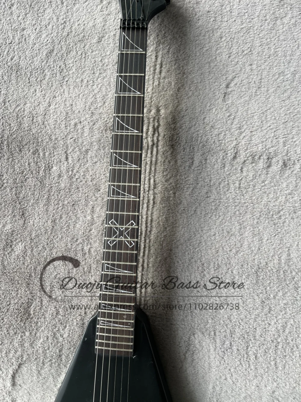 

Matte black guitar, black tremolo bridge, horn inlays on the fingerboard, maple neck set in solid body, sealed pickups.