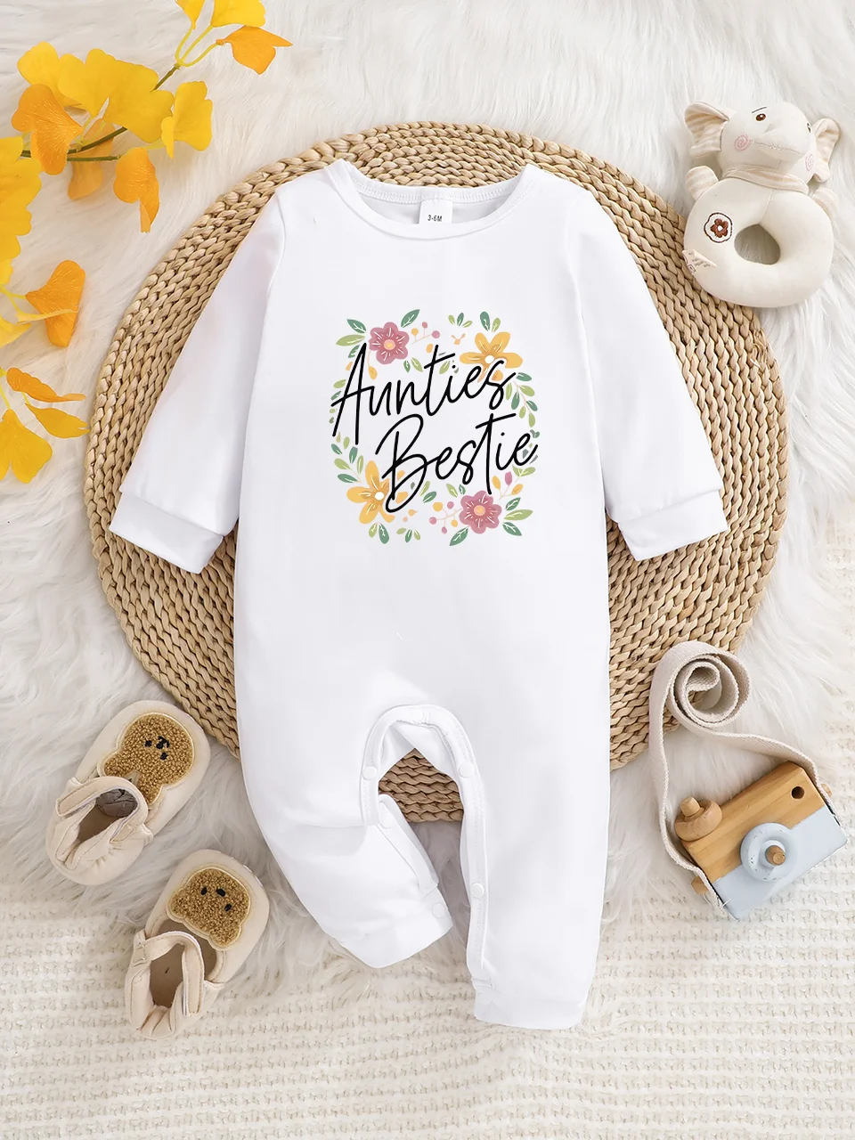A baby long-sleeved onesie with interesting letter prints. It features a buttoned design for easy putting on and taking off, and