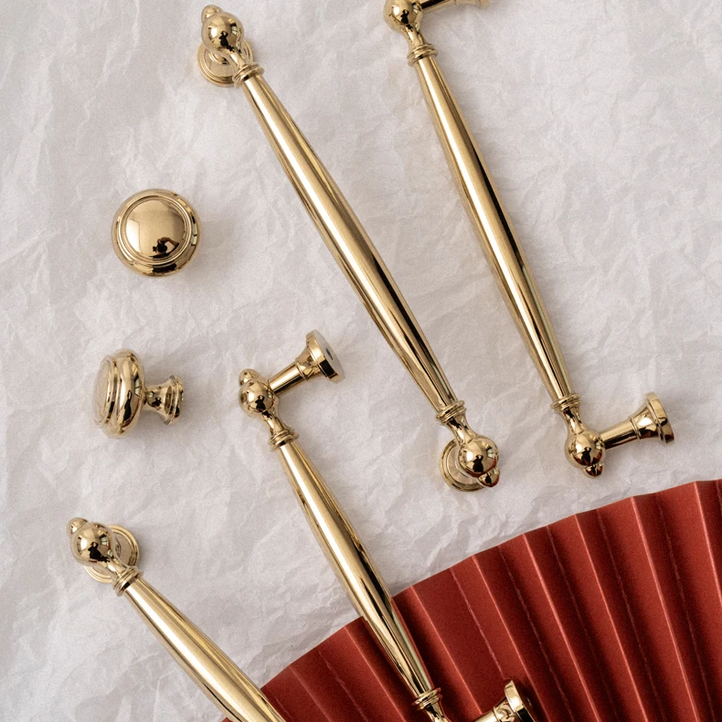 Brass pull handles and round knob arranged on marble