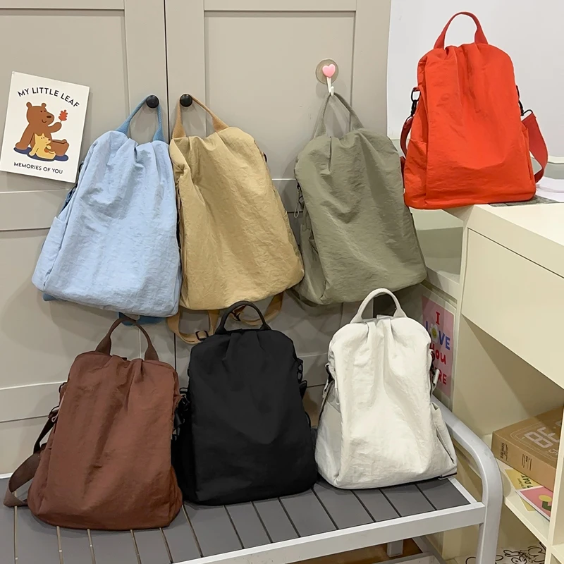 tendencia-concisa-luz-nailon-doce-sacos-de-lona-casual-versatil-grande-capacidade-sacos-escolares-2026-nova-viagem-ao-ar-livre-moda-mochila