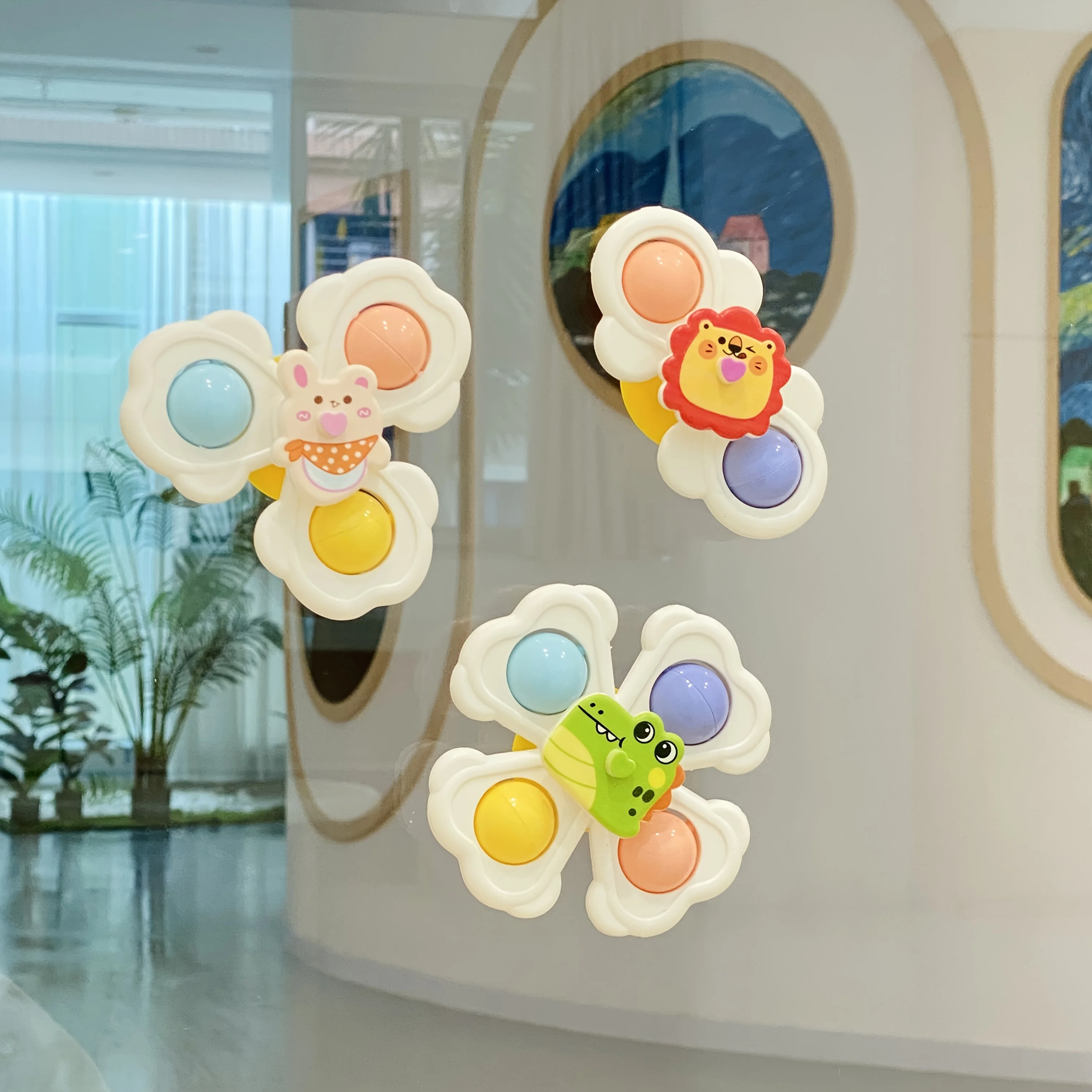 Un set di tre trottole con ventosa per animali dei cartoni animati per neonati progettate per migliorare la coordinazione occhio-mano durante le prime prime