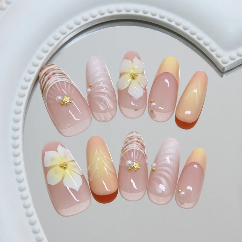 Handmade almond nails with nude pink gradient, decorated with 3D shells, plumeria flowers & pearls. Reusable, perfect for daily