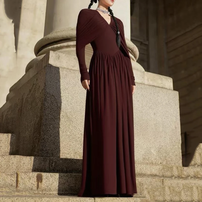 

A court-style multi-layered dress with a pleated V-neck and a cinched waist, a long knitted dress for the 2025 autumn collection