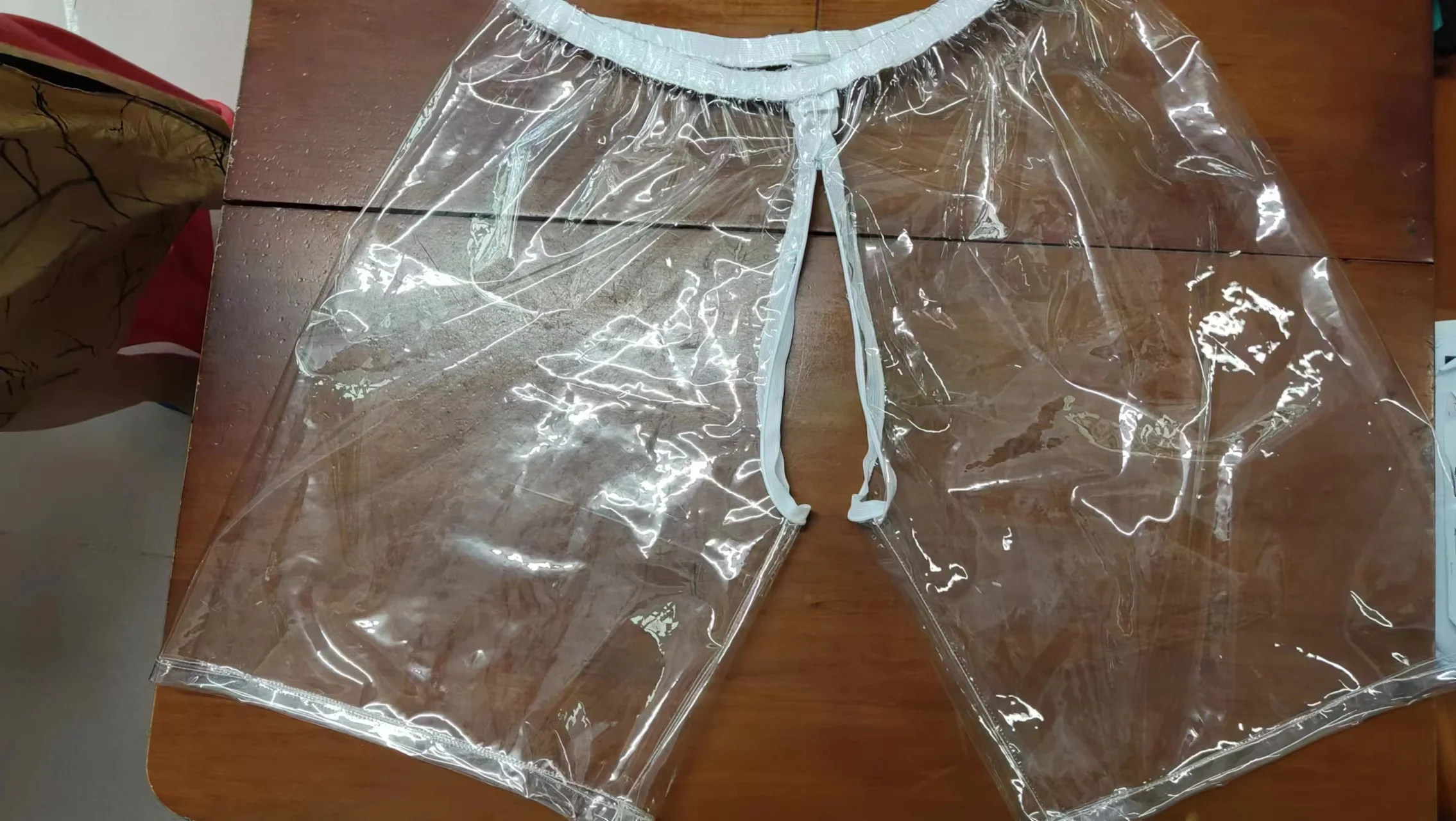 Pantaloncini estivi da uomo e da donna Pantaloni aperti PVC trasparente Morbido silenzioso Pantaloni da spiaggia con cerniera sexy Prospettiva di boxer in plastica