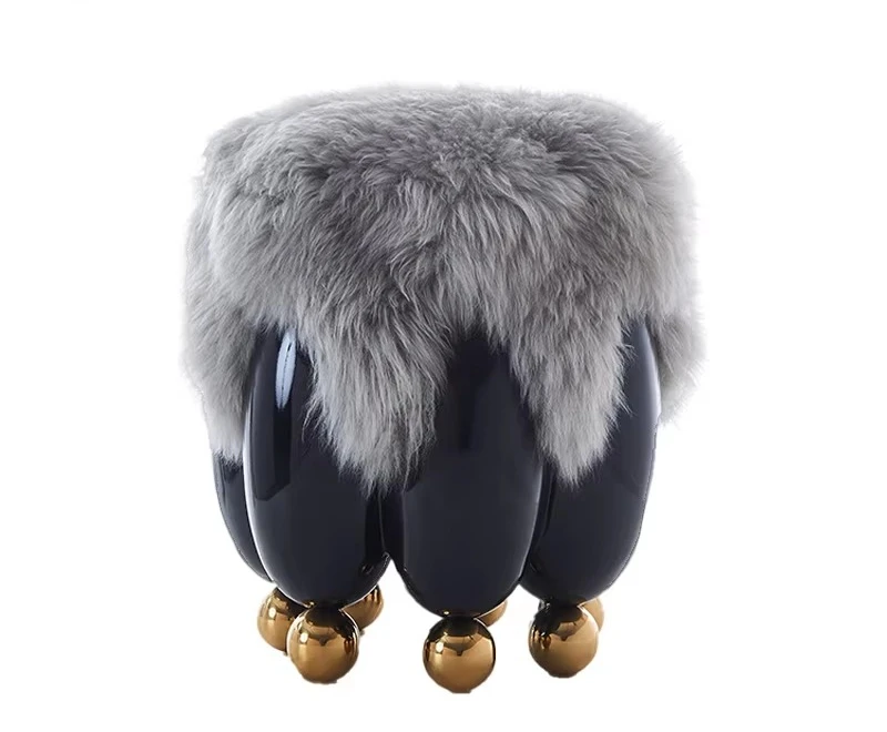 Modern art style glossy black fiberglass decorative stool with rounded profile and golden stainless steel spherical feet