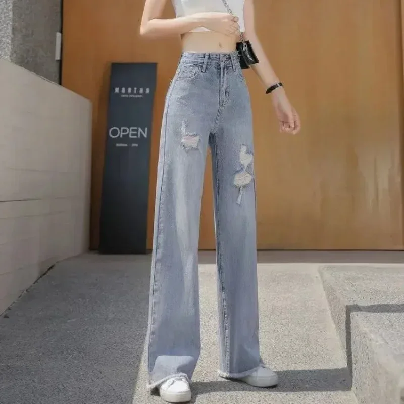 Celana panjang robek wanita, celana longgar kaki lebar dengan lubang Jeans dasar grosir Xxl Emo 2025 gaya Korea longgar celana koboi untuk wanita