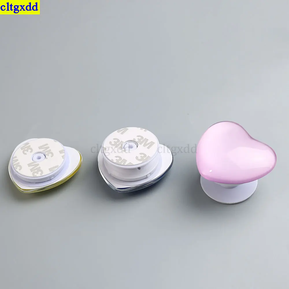 Cltgxdd, 1 pieza, pegamento transparente en forma de gota, soporte para teléfono 3D brillante en forma de corazón, soporte para airbag, agarre universal para teléfono plegable estirable