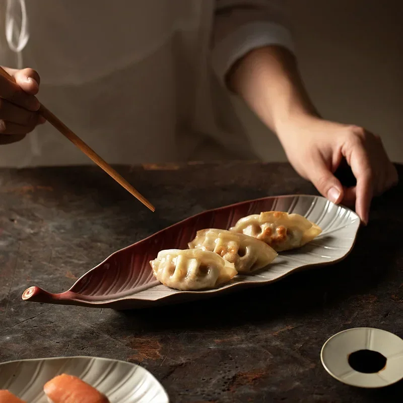 Japanese retro kiln leaves sushi plate commercial ceramic snack plate jiaozi sashimi long plate saury plate.