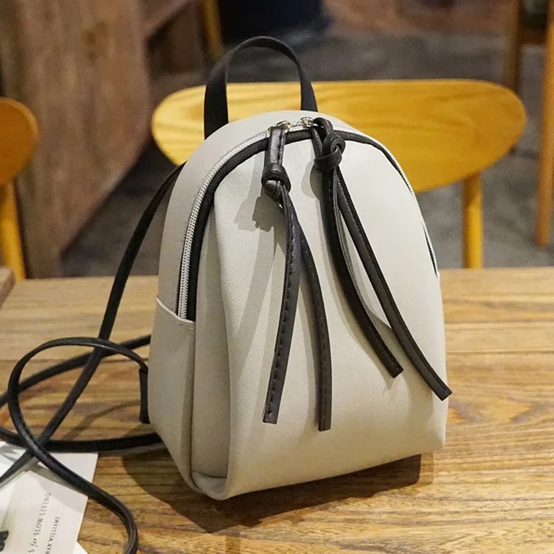 Mini mochila de couro PU para mulheres, bolsa de ombro pequena com borla zíper, mochila escolar feminina para adolescentes